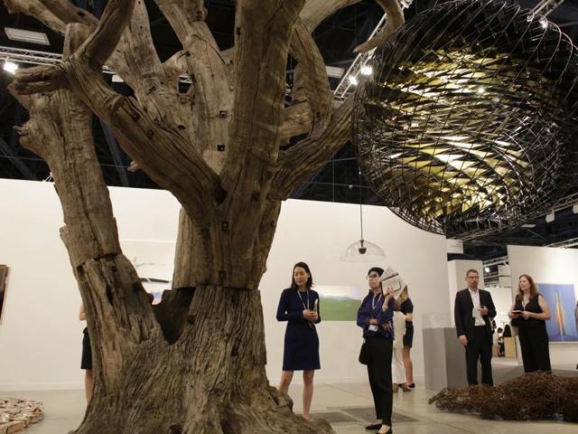 A tree sculpture by artist Ai Weiwei and a globe sculpture by artist Olafur Eliasson are displayed at Galerie neugerriemschneider, Wednesday, December 2, 2015, at Art Basel Miami Beach, in Miami Beach, Florida. (AP) A tree sculpture by artist Ai Weiwei and a globe sculpture by artist Olafur Eliasson are displayed at Galerie neugerriemschneider, Wednesday, December 2, 2015, at Art Basel Miami Beach, in Miami Beach, Florida. (AP)