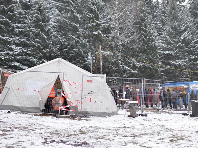 Migrants wait in a line for warm clothes as they stand on a snow covered meadow at the border between Austria and Germany, in Hanging Austria. (AP Photo) Migrants wait in a line for warm clothes as they stand on a snow covered meadow at the border between Austria and Germany, in Hanging Austria. (AP Photo)