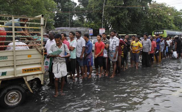 Flood-affected people queue up for food in Chennai. (AP Photo) Flood-affected people queue up for food in Chennai. (AP Photo)