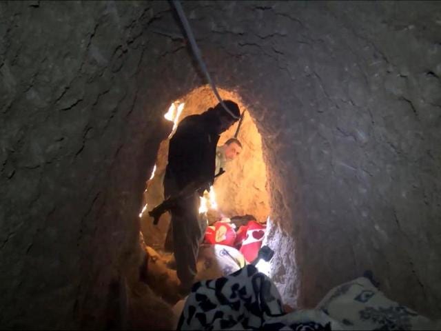 Kurdish security forces in a tunnel complex in Sinjar used by Islamic State fighters to hide from airstrikes. The UN human rights office received reports of finding 16 mass graves in the town after was freed from the militants.(AP File)