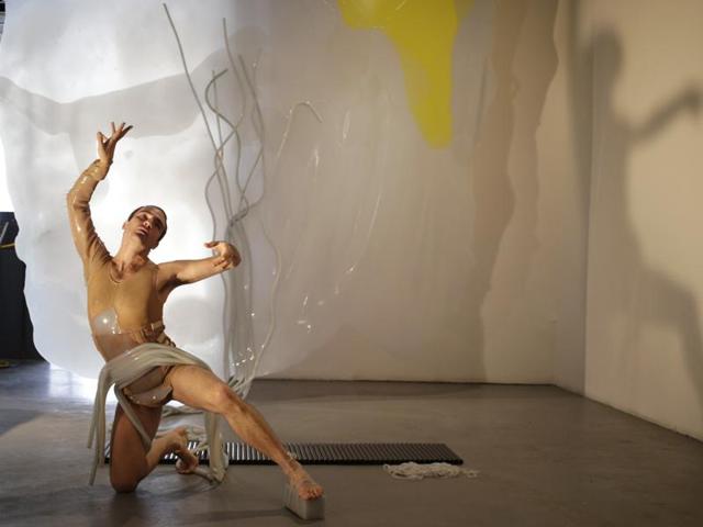 Dancer Silas Riener performs among an installation by artist Martha Friedman titled Pore, during Miami Art Week, Thursday, December 3, 2015, at the Locust Projects in the Design District neighbourhood of Miami. The piece consists of four vividly coloured sheets of rubber with a costume attached, coloured to reference the four humours. (AP) Dancer Silas Riener performs among an installation by artist Martha Friedman titled Pore, during Miami Art Week, Thursday, December 3, 2015, at the Locust Projects in the Design District neighbourhood of Miami. The piece consists of four vividly coloured sheets of rubber with a costume attached, coloured to reference the four humours. (AP)