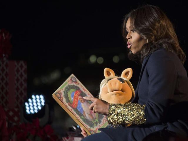 First Lady Michelle Obama and Muppet Miss Piggy read Twas the Night Before Christmas to children after lighting the National Christmas Tree in President's Park outside the White House in Washington on Thursday. (AFP)