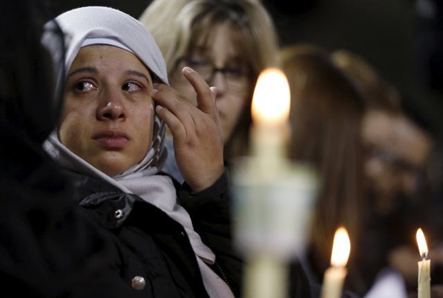 An attendee reflects on the tragedy of Wednesday's attack during a candlelight vigil in San Bernardino, California, December 3, 2015. (REUTERS) An attendee reflects on the tragedy of Wednesday's attack during a candlelight vigil in San Bernardino, California, December 3, 2015. (REUTERS)