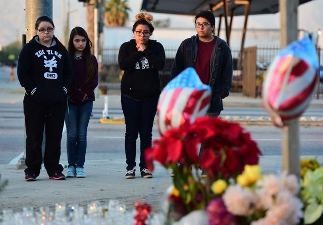 People visit a makeshift memorial for the victims of a mass shooting near the Inland Regional Center in San Bernardino. (AFP)