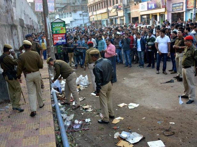 Police officials inspecting the blast site at Jail Road in Guwahati. (PTI) Police officials inspecting the blast site at Jail Road in Guwahati. (PTI)