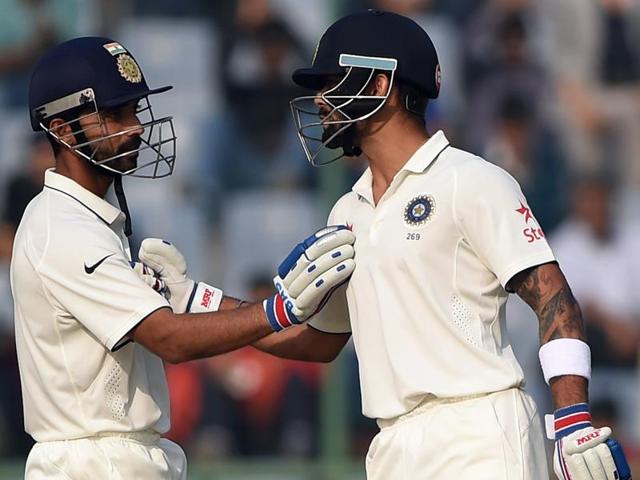 Virat Kohli (R) is congratulated by Ajinkya Rahane as he completes his half-century (50 runs) . (AFP Photo) Virat Kohli (R) is congratulated by Ajinkya Rahane as he completes his half-century (50 runs) . (AFP Photo)