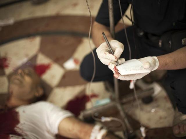 In this file photo, a Syrian doctor notes the name of a severely wounded man at Dar al-Shifaa hospital in Aleppo. (AP) In this file photo, a Syrian doctor notes the name of a severely wounded man at Dar al-Shifaa hospital in Aleppo. (AP)