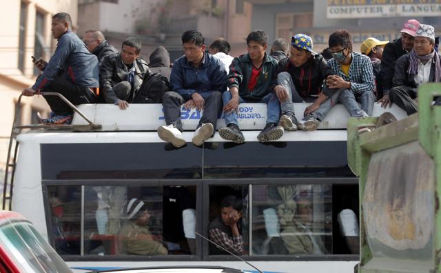 Nepalese people sit on the top of a crowded public bus in Kathmandu, Nepal. The Madhesi blockade of a key border point with India is leaving Nepal with only about 15% of its normal supply of gasoline, diesel and cooking fuel, and creating shortages of other goods including food and medicine. (AP Photo)