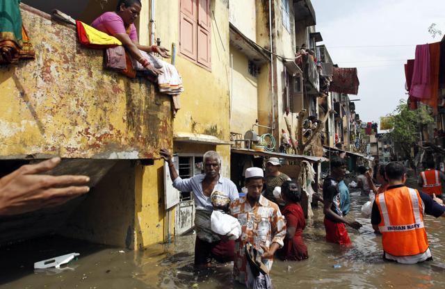 People receive food packets distributed by navy personnel in Chennai on Friday, Dec. 4, 2015. Large parts of the city still remain flooded due to the rains . (AP) People receive food packets distributed by navy personnel in Chennai on Friday, Dec. 4, 2015. Large parts of the city still remain flooded due to the rains . (AP)