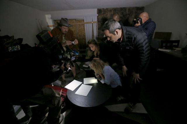 News media look at documents left inside the home of suspects Syed Rizwan Farook and Tashfeen Malik in Redlands, California. (REUTERS) News media look at documents left inside the home of suspects Syed Rizwan Farook and Tashfeen Malik in Redlands, California. (REUTERS)