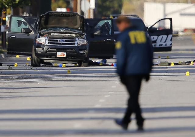 FBI and police continue their investigation around the area of the SUV vehicle where two suspects were shot by police following a mass shooting in San Bernardino, California. (Reuters Photo) FBI and police continue their investigation around the area of the SUV vehicle where two suspects were shot by police following a mass shooting in San Bernardino, California. (Reuters Photo)