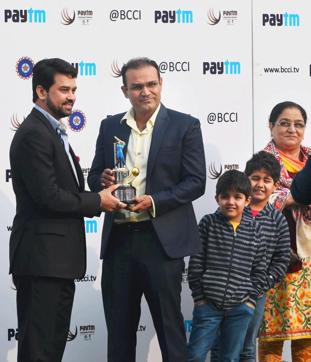 Virender Sehwag felicitated by BCCI secretary Anurag Thakur before the start of the India vs South Africa Test match in Delhi on December 3. (PTI Photo) Virender Sehwag felicitated by BCCI secretary Anurag Thakur before the start of the India vs South Africa Test match in Delhi on December 3. (PTI Photo)