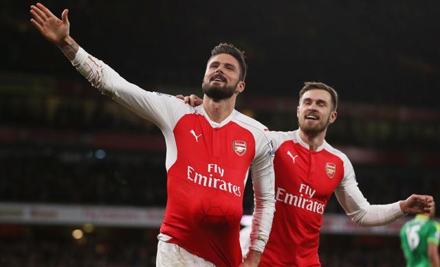 Olivier Giroud, left, celebrates scoring the second goal for Arsenal with Aaron Ramsey by putting the ball under his shirt. (Reuters Photo)
