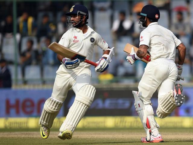 India's captain Virat Kohli, center and batsman Ajinkya Rahane, left run between the wickets as South Africa's bowler Kyle Abbott, right watches on the third day of the fourth test cricket match between India and South Africa in New Delhi. (AP) India's captain Virat Kohli, center and batsman Ajinkya Rahane, left run between the wickets as South Africa's bowler Kyle Abbott, right watches on the third day of the fourth test cricket match between India and South Africa in New Delhi. (AP)