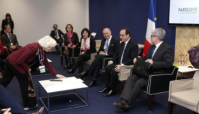 Hollande (second right) and foreign affairs minister Laurent Fabius (third from right) attend a meeting with French negotiators including France's climate ambassador Laurence Tubiana (left) on Saturday at the World Climate Change Conference 2015 (COP21). (AFP)