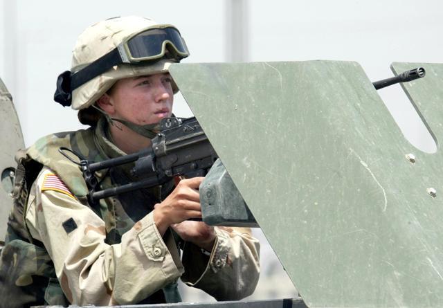 A June 13, 2003, file photo of a female US soldier manning a machine gun on a vehicle in the northern Iraqi city of Mosul. Carter believes the inclusion of women will, over time, improve combat effectiveness. (AFP Photo) A June 13, 2003, file photo of a female US soldier manning a machine gun on a vehicle in the northern Iraqi city of Mosul. Carter believes the inclusion of women will, over time, improve combat effectiveness. (AFP Photo)