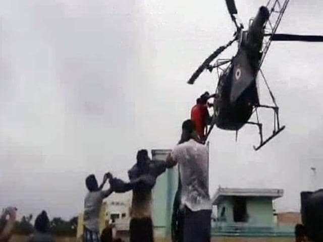 A nine-month pregnant woman, Deepthi Velchamy, being airlifted to safety by an IAF helicopter in Chennai. Mrs. Velchamy went into labour and gave birth to healthy twin girls at a hospital in the city on Monday. (PTI Photo) A nine-month pregnant woman, Deepthi Velchamy, being airlifted to safety by an IAF helicopter in Chennai. Mrs. Velchamy went into labour and gave birth to healthy twin girls at a hospital in the city on Monday. (PTI Photo)