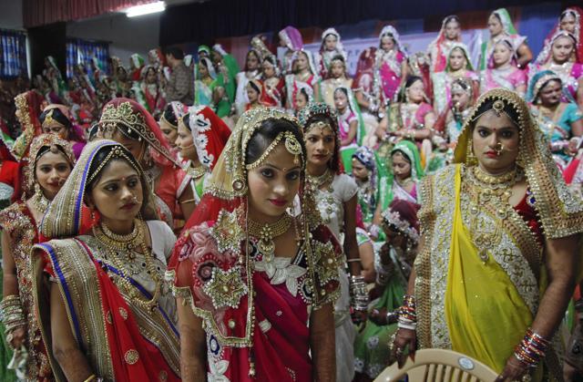 Brides leave after a group photo before a mass wedding hosted by a diamond trader in Surat. (AP) Brides leave after a group photo before a mass wedding hosted by a diamond trader in Surat. (AP)