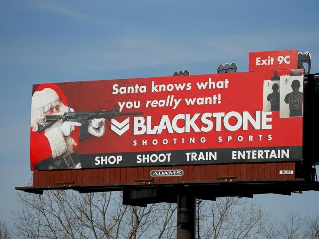 A billboard for Blackstone Shooting Sports showing a man dressed as Santa Claus holding a firearm is seen in Charlotte, North Carolina. (REUTERS) A billboard for Blackstone Shooting Sports showing a man dressed as Santa Claus holding a firearm is seen in Charlotte, North Carolina. (REUTERS)