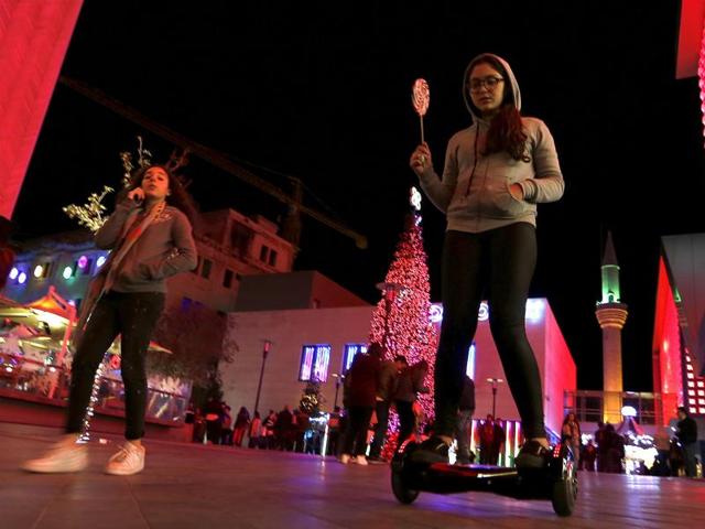 According to Biblical records, Paul and Peter converted Phoenicians (inhabitants of modern-day Lebanon and Syria) to Christianity. A girl rides a two-wheeled self-balancing scooter near a Christmas tree in downtown Beirut, Lebanon December 5, 2015. (REUTERS)