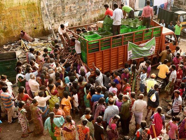 Residents seeking relief materials from volunteers at Kotturpuram, one of the worst flood-hit localities in Chennai. (PTI Photo)