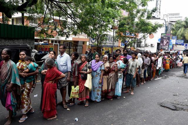 Flood affected people stand in a long queue to get relief materials at Kotturpuram, one of the worst flood-hit localities in Chennai on Sunday. (PTI) Flood affected people stand in a long queue to get relief materials at Kotturpuram, one of the worst flood-hit localities in Chennai on Sunday. (PTI)