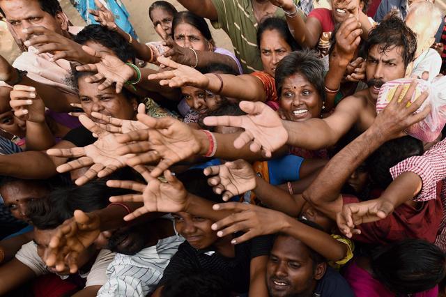 Residents seeking relief material from volunteers at Kotturpuram, a flooded colony in southern Chennai on Monday. (PTI) Residents seeking relief material from volunteers at Kotturpuram, a flooded colony in southern Chennai on Monday. (PTI)
