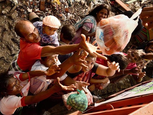 People reach out to collect relief materials being distributed in Chennai. The worst flooding in a century in Tamil Nadu has left scores of people dead since November. (AP) People reach out to collect relief materials being distributed in Chennai. The worst flooding in a century in Tamil Nadu has left scores of people dead since November. (AP)