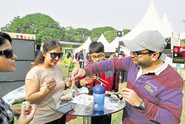 Food lovers eat on a warm Sunday afternoon on the last day of Hindustan Times The Gourmet High Street held at Leisure Valley Park in Sector 29. (Sanjeev Verma/HT Photo)