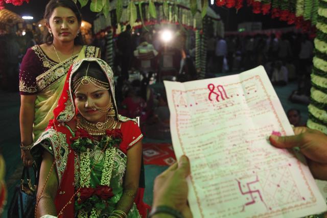 Bride Riddhi Saiyad weds groom Vijay Moradiya, during a mass wedding hosted by a diamond trader in Surat. (AP) Bride Riddhi Saiyad weds groom Vijay Moradiya, during a mass wedding hosted by a diamond trader in Surat. (AP)