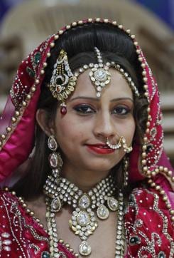 Bride Nagmabegum Qadri looks during a group photo session before a mass wedding hosted by a diamond trader in Surat. (AP) Bride Nagmabegum Qadri looks during a group photo session before a mass wedding hosted by a diamond trader in Surat. (AP)