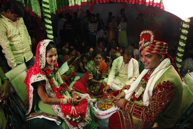 Riddhi Saiyad, left and groom Vijay Moradiya sit for a marriage ritual. (AP) Riddhi Saiyad, left and groom Vijay Moradiya sit for a marriage ritual. (AP)