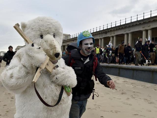 Performers walk during a march against climate change in Ostend, Belgium.(REUTERS)
