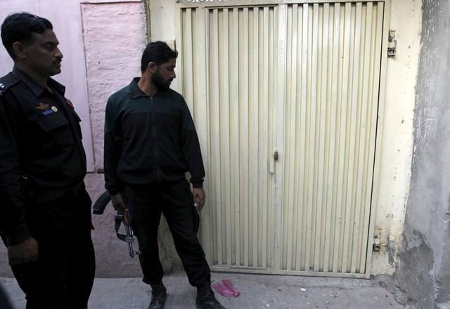 Police, escorting members of the media, look at the padlocked door of relatives of Tashfeen Malik in Karor Lan Esan, Pakistan. (REUTERS) Police, escorting members of the media, look at the padlocked door of relatives of Tashfeen Malik in Karor Lan Esan, Pakistan. (REUTERS)