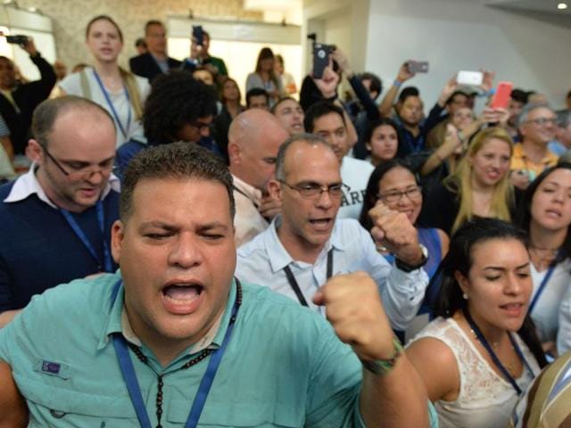 Venezuelan opposition Democratic Unity Movement (MUD) party members celebrate after knowing the first results of the legislative election. (AFP) Venezuelan opposition Democratic Unity Movement (MUD) party members celebrate after knowing the first results of the legislative election. (AFP)