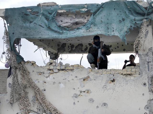 An Afghan security man stands guard at a police station after clashes between the Afghan police and Taliban militants in the city of Kandahar, Afghanistan.(AP Photo)