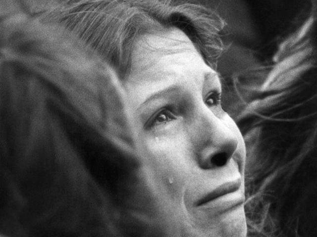 A woman weeps during a ten minute silent vigil for John Lennon held in front of Trinity Church in Boston on December 14, 1980. An estimated crowd of 2,000 people came to honour the former Beatle. (AP)
