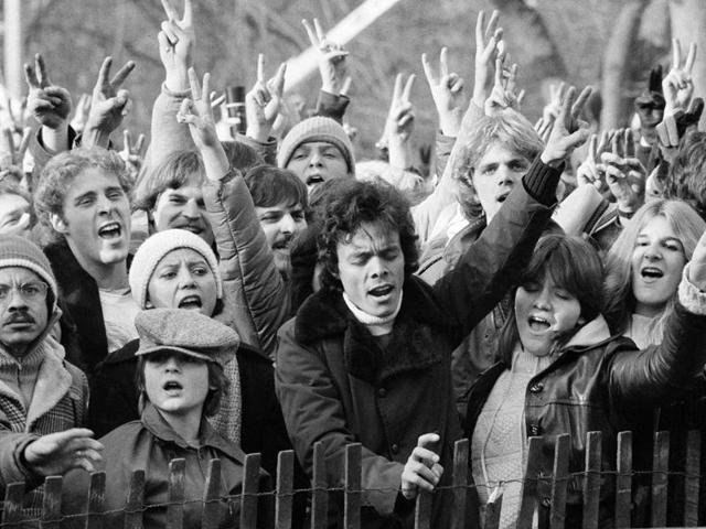 People paying their tribute to Lennon by singing ‘Give Peace A Chance’ in New York’s Central Park on December 14, 1980. (AP)