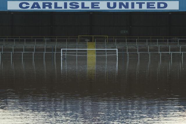 Flood water covers the pitch and some of the stands at Carlisle United Football Club's Brunton Park stadium in Carlisle. (AFP Photo) Flood water covers the pitch and some of the stands at Carlisle United Football Club's Brunton Park stadium in Carlisle. (AFP Photo)