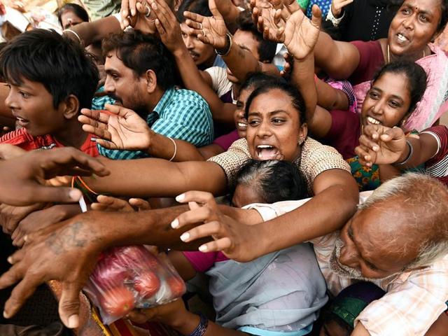 Residents seeking relief materials from volunteers at Kotturpuram, one of the worst flood-hit localities in Chennai .(PTI) Residents seeking relief materials from volunteers at Kotturpuram, one of the worst flood-hit localities in Chennai .(PTI)