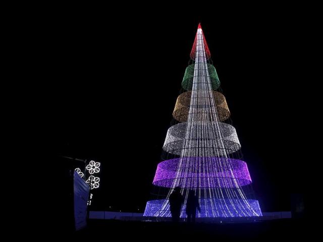 People look at an illuminated Christmas tree at the Park Simon Bolivar in Bogota, Colombia December 7, 2015. Colombians light up candles on December 7 every year to mark the start of Christmas festivities. (REUTERS) People look at an illuminated Christmas tree at the Park Simon Bolivar in Bogota, Colombia December 7, 2015. Colombians light up candles on December 7 every year to mark the start of Christmas festivities. (REUTERS)