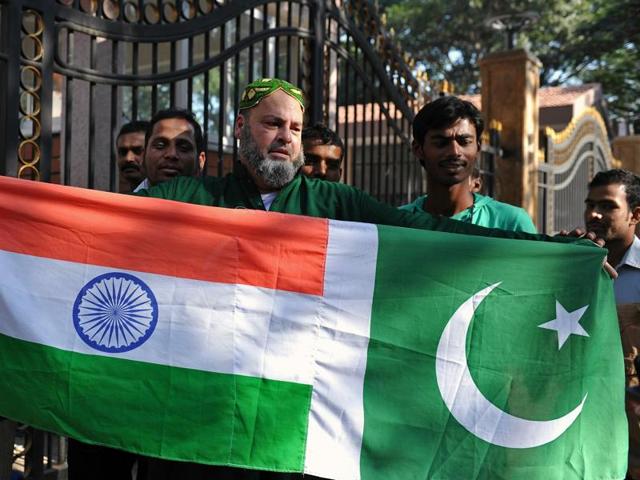 This file photograph shows Mohammed Bashir, a US-based Pakistani cricket fan, holding up the national flags of India and Pakistan. (AFP File Photo) This file photograph shows Mohammed Bashir, a US-based Pakistani cricket fan, holding up the national flags of India and Pakistan. (AFP File Photo)
