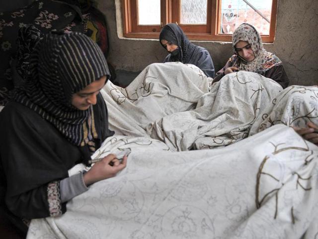 Kashmiri women do embroidery on window curtains at a state-run centre in Shelwat in north Kashmir. (Waseem Andrabi/ HT Photo)