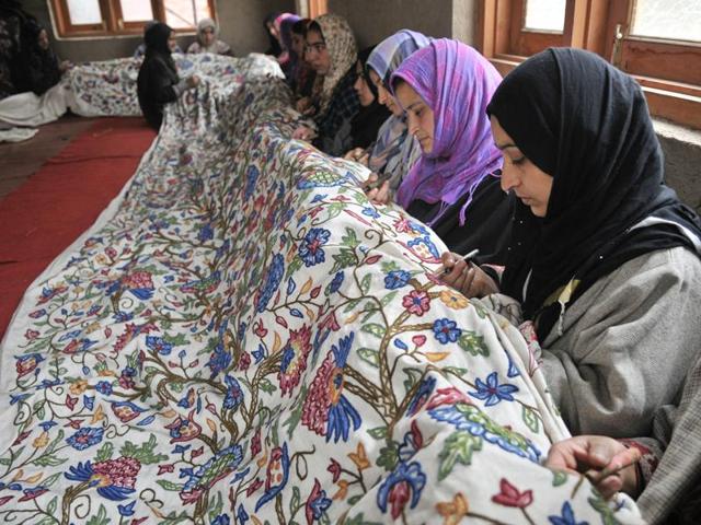 Kashmiri women work as a team to bring out the finest embroidery at a state-run centre in Shelwat, in north Kashmir. (Waseem Andrabi/ HT Photo)