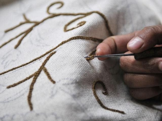 A Kashmiri woman doing intricate embroidery on window curtains at a state-run centre in Shelwat in north Kashmir. (Waseem Andrabi/HT Photo)