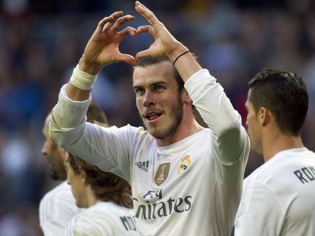 Real Madrid's Welsh forward Gareth Bale gestures as he celebrates a goal during the Spanish league football match Real Madrid CF vs Getafe CF at the Santiago Bernabeu stadium in Madrid on December 5, 2015.(AFP Photo)