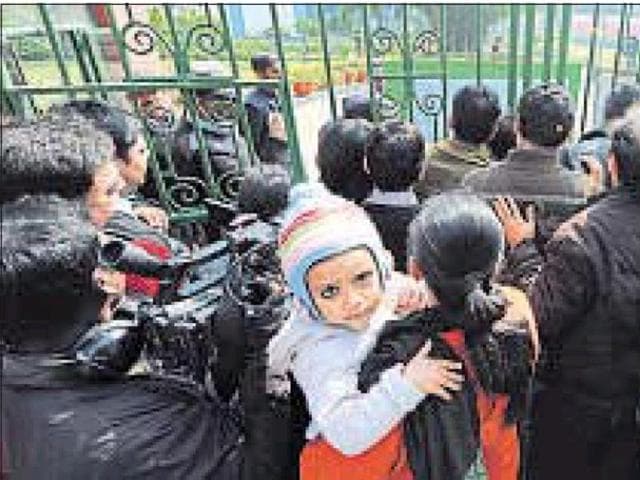 Parents of children waiting outside a school during the admission season last year. (HT file photo) Parents of children waiting outside a school during the admission season last year. (HT file photo)