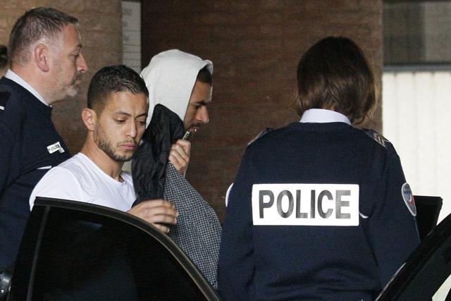 Real Madrid striker Karim Benzema (C) leaving the court house in Versailles, near Paris. (AFP File Photo)