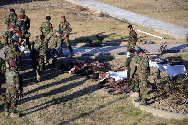Members of the Afghan military stand near bodies of Taliban militants wearing Afghan army uniforms who were killed during clashes. (AFP) Members of the Afghan military stand near bodies of Taliban militants wearing Afghan army uniforms who were killed during clashes. (AFP)