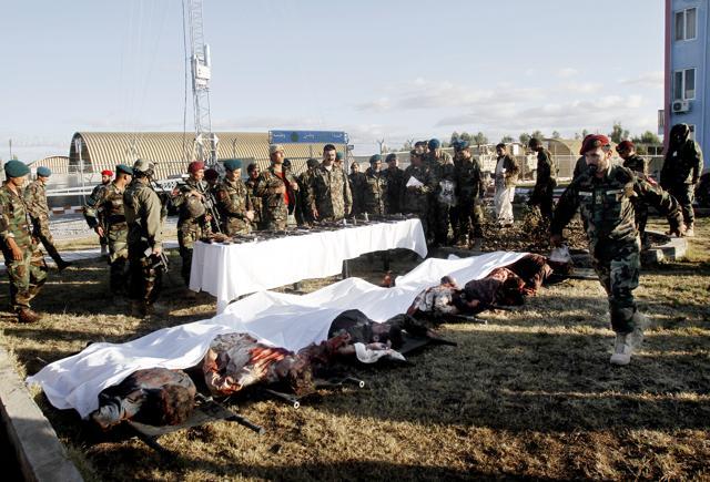 Afghan security forces stand in front of the dead bodies of Taliban fighters after clashes in Kandahar Airfield. (AP) Afghan security forces stand in front of the dead bodies of Taliban fighters after clashes in Kandahar Airfield. (AP)
